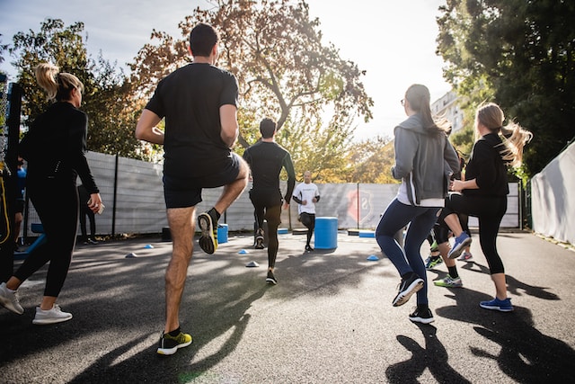 An outdoor group workout class in the sun