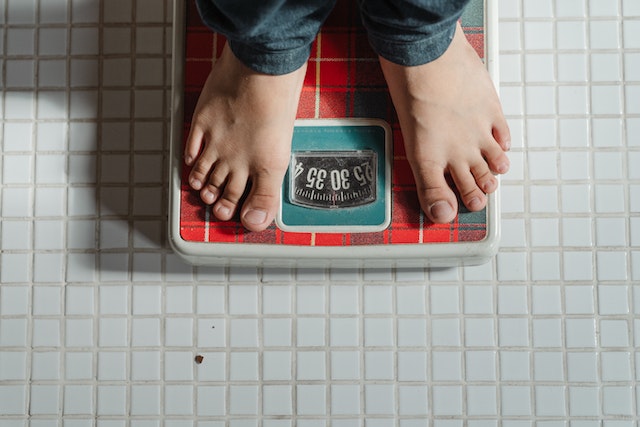 Man weighing himself on the scale