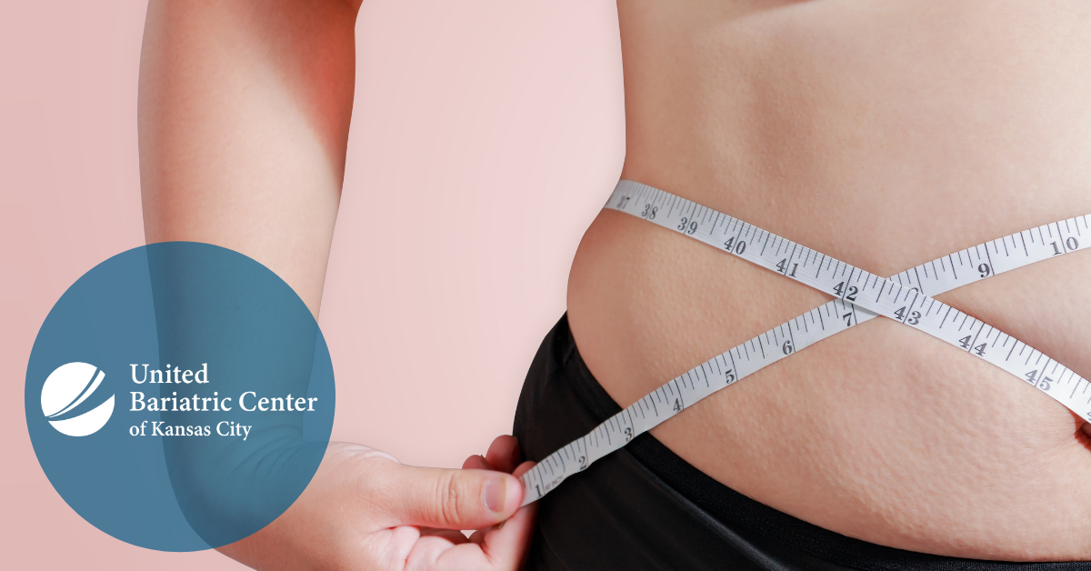 Woman measuring her waistline