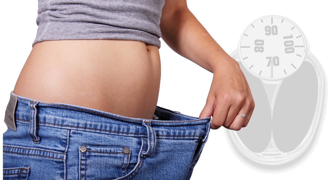 Woman losing weight with flat belly & old jeans size